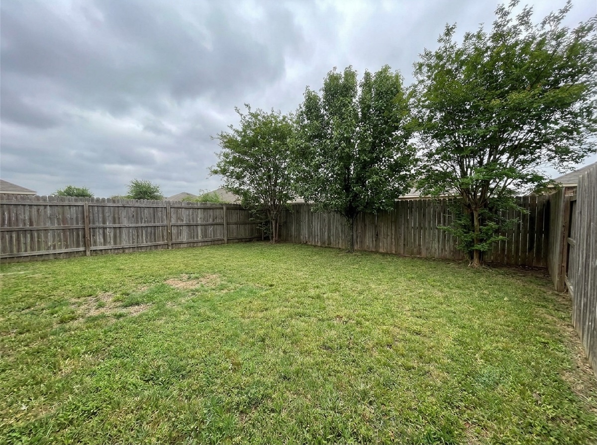 Empty corner of a backyard before an ADU was built